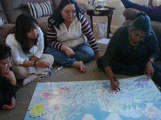 Women gather around a map